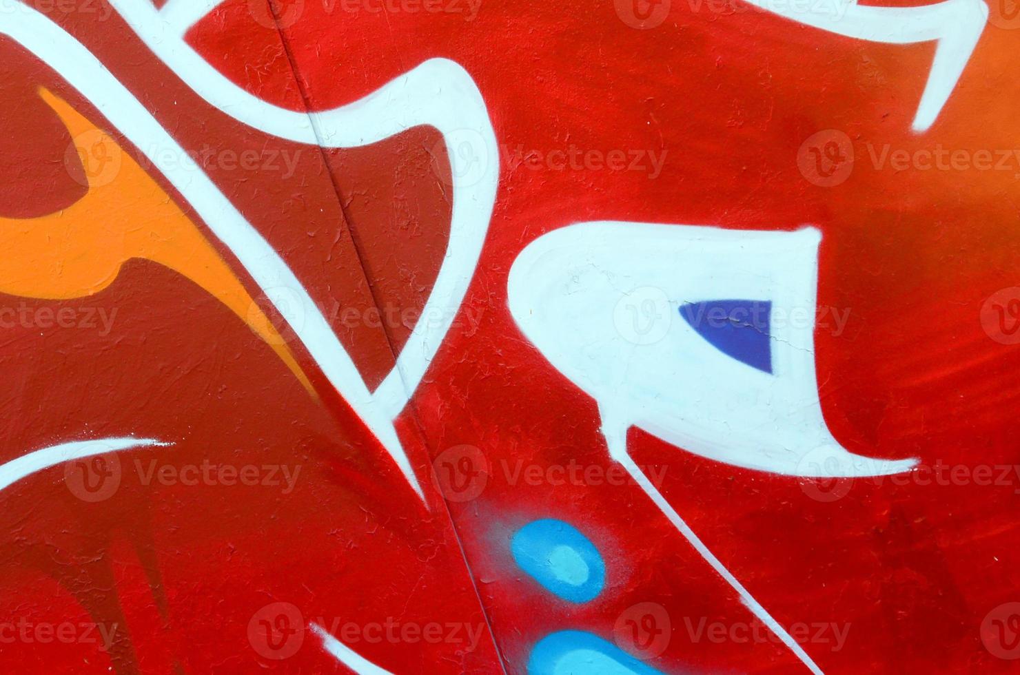Fragment of graffiti drawings. The old wall decorated with paint stains in the style of street art culture. Colored background texture photo