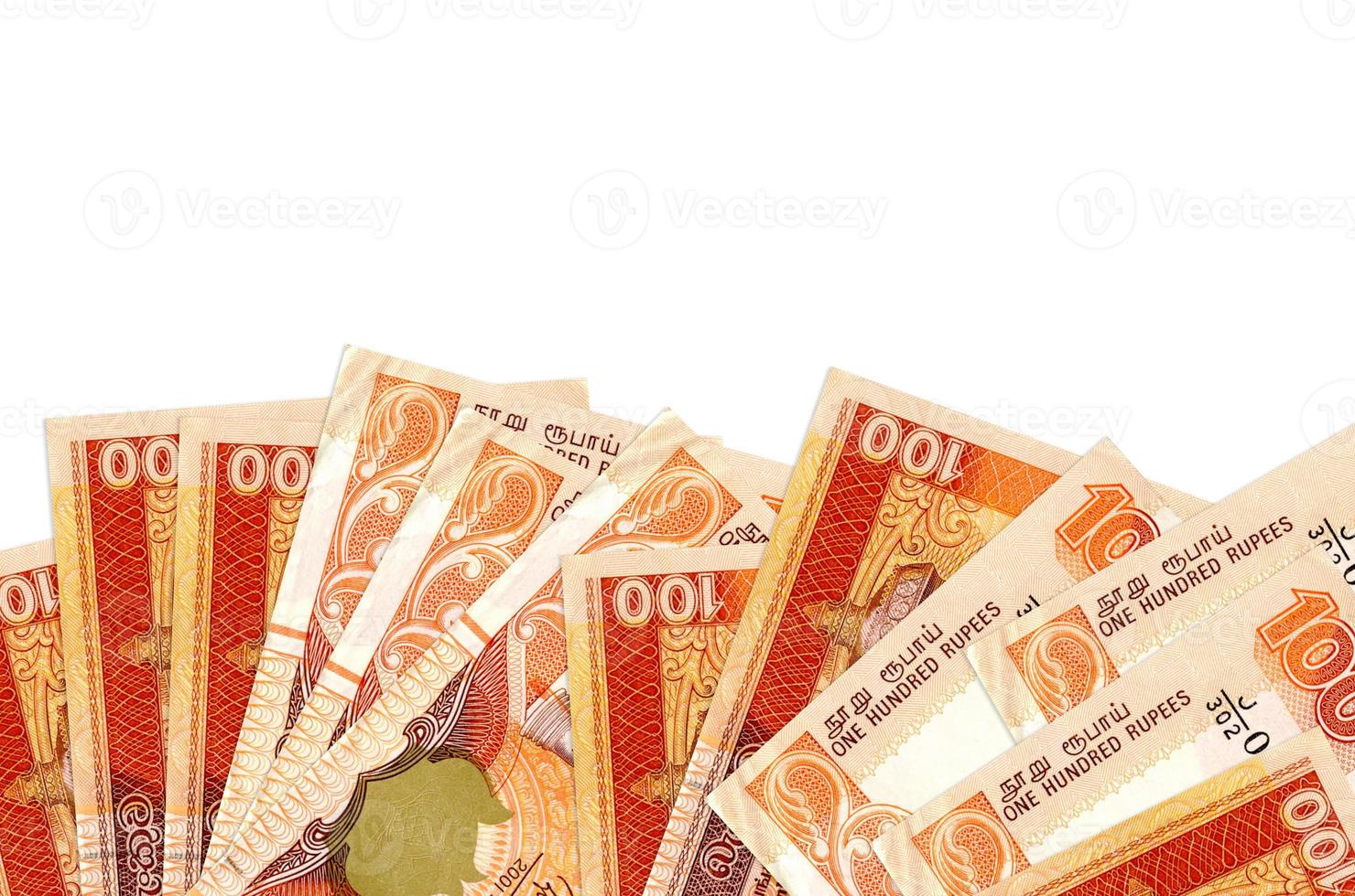 100 Sri Lankan rupees bills lies on bottom side of screen isolated on white background with copy space. Background banner template photo
