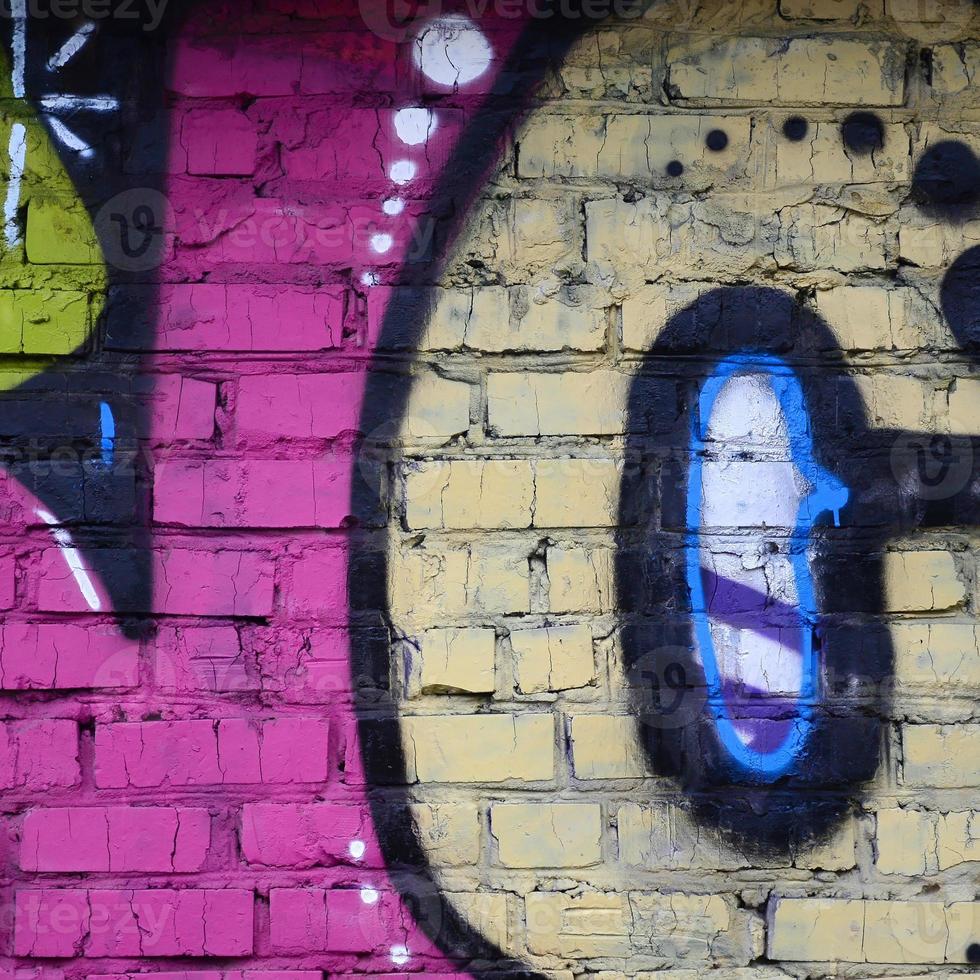 fragmento de dibujos de graffiti. la antigua muralla decorada con manchas de pintura al estilo de la cultura del arte callejero. textura de fondo de color foto