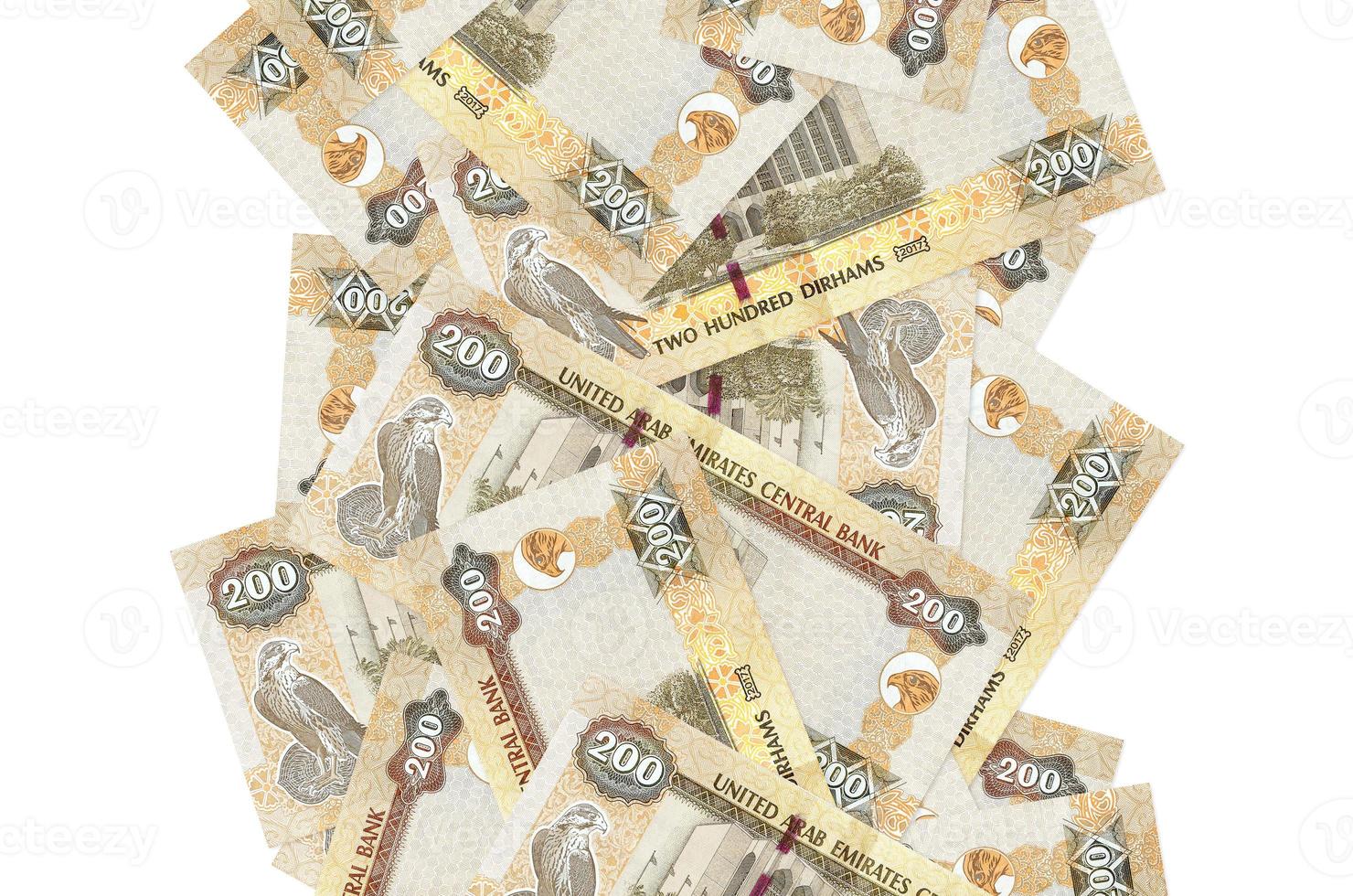 200 UAE dirhams bills flying down isolated on white. Many banknotes falling with white copyspace on left and right side photo
