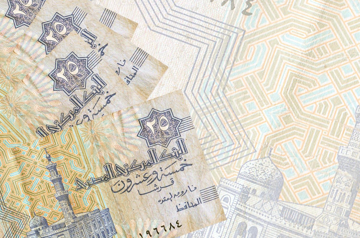 25 Egyptian piastres bills lies in stack on background of big semi-transparent banknote. Abstract business background photo