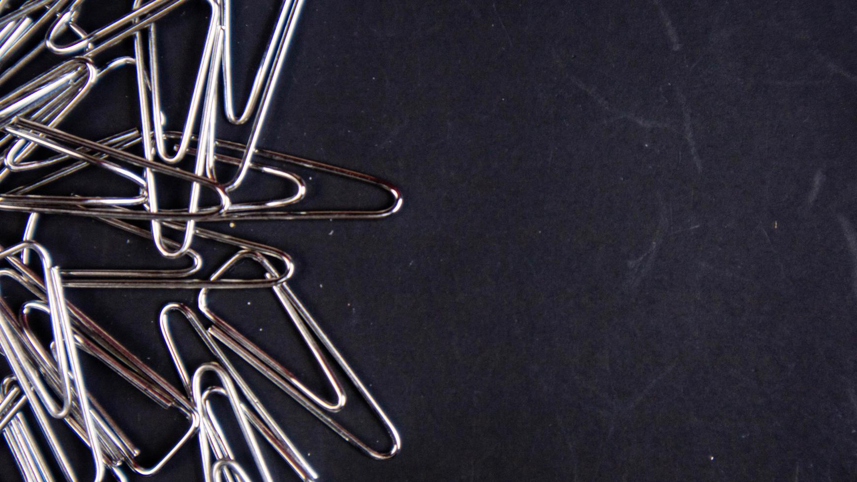 a paper clip on a black background photo