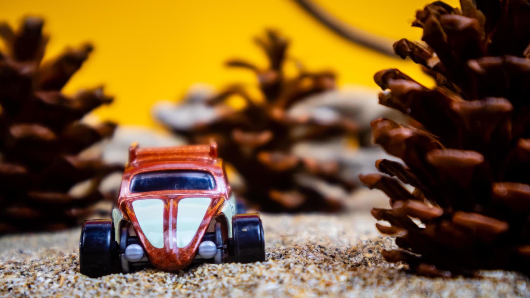 Minahasa, Indonesia December 2022, the toy car among the pine cones photo