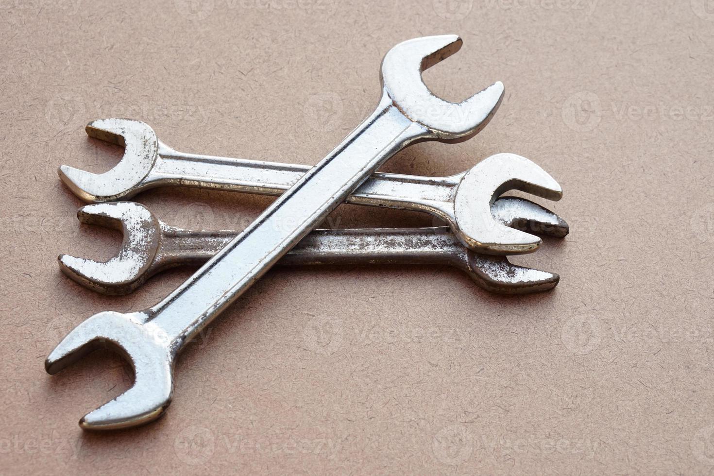 Metal wrenches  isolated on brown. Concept, handyman, mechanic tools. Spanners. Equipment for fixing or repairing, renovation in daily life. photo