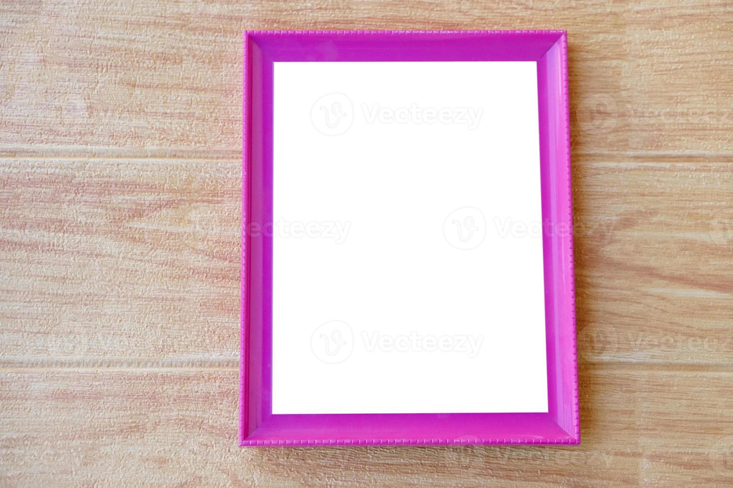 Pink photo frame  on wooden background. Copy space for adding text or photos. Concept, Proud, memories and nostalgia. Exhibition, art gallery. Photography.