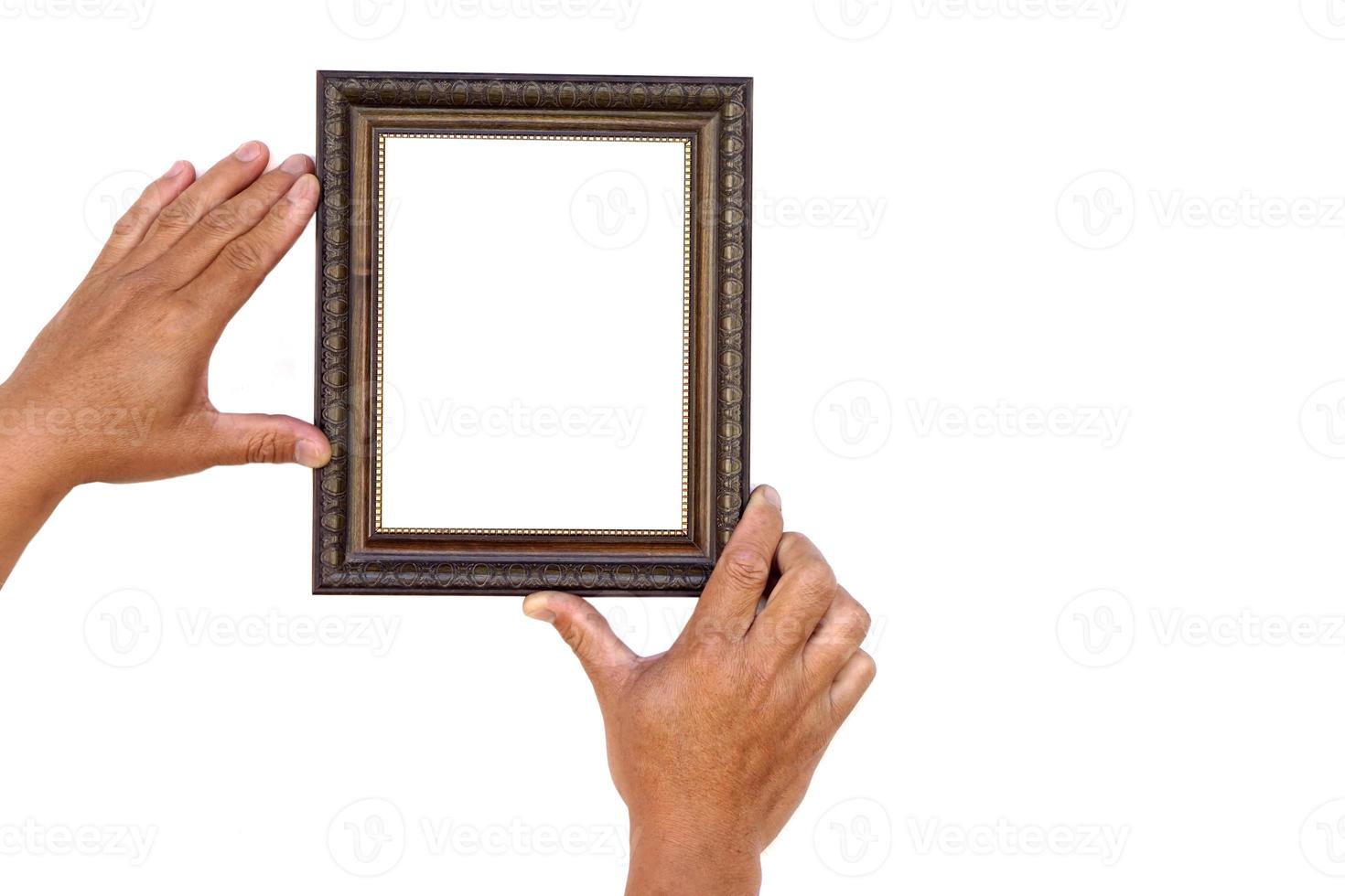 Hands hold photo frame, isolated on white background. Copy space for adding text or photos. Concept, Proud, memories and nostalgia. Exhibition, art gallery. Photography.