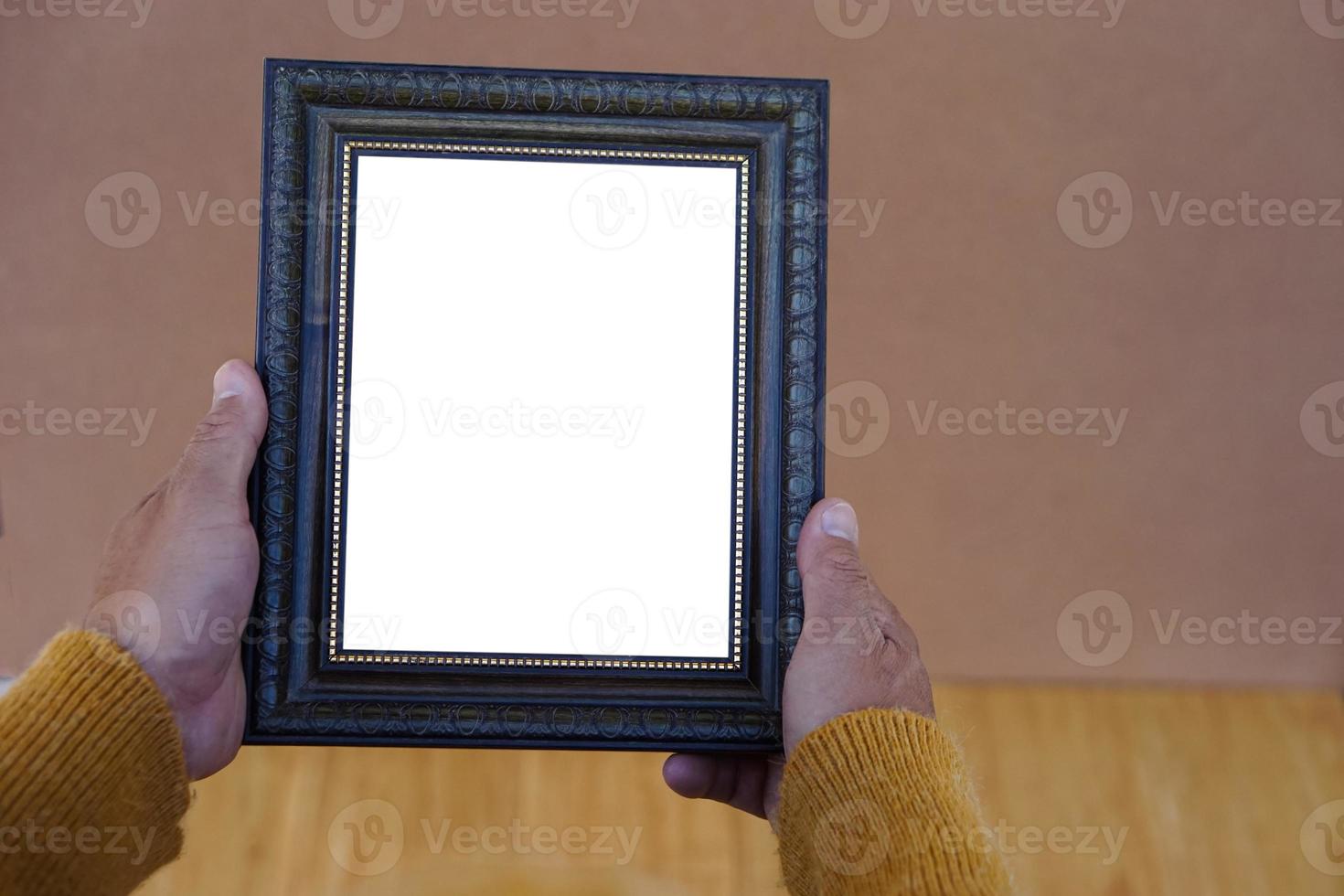 Closeup senior woman hands holds blank wooden photo frame , Copy space for adding text or photos.  Concept, Proud, memories and nostalgia. Exhibition, art gallory. Photograpy.