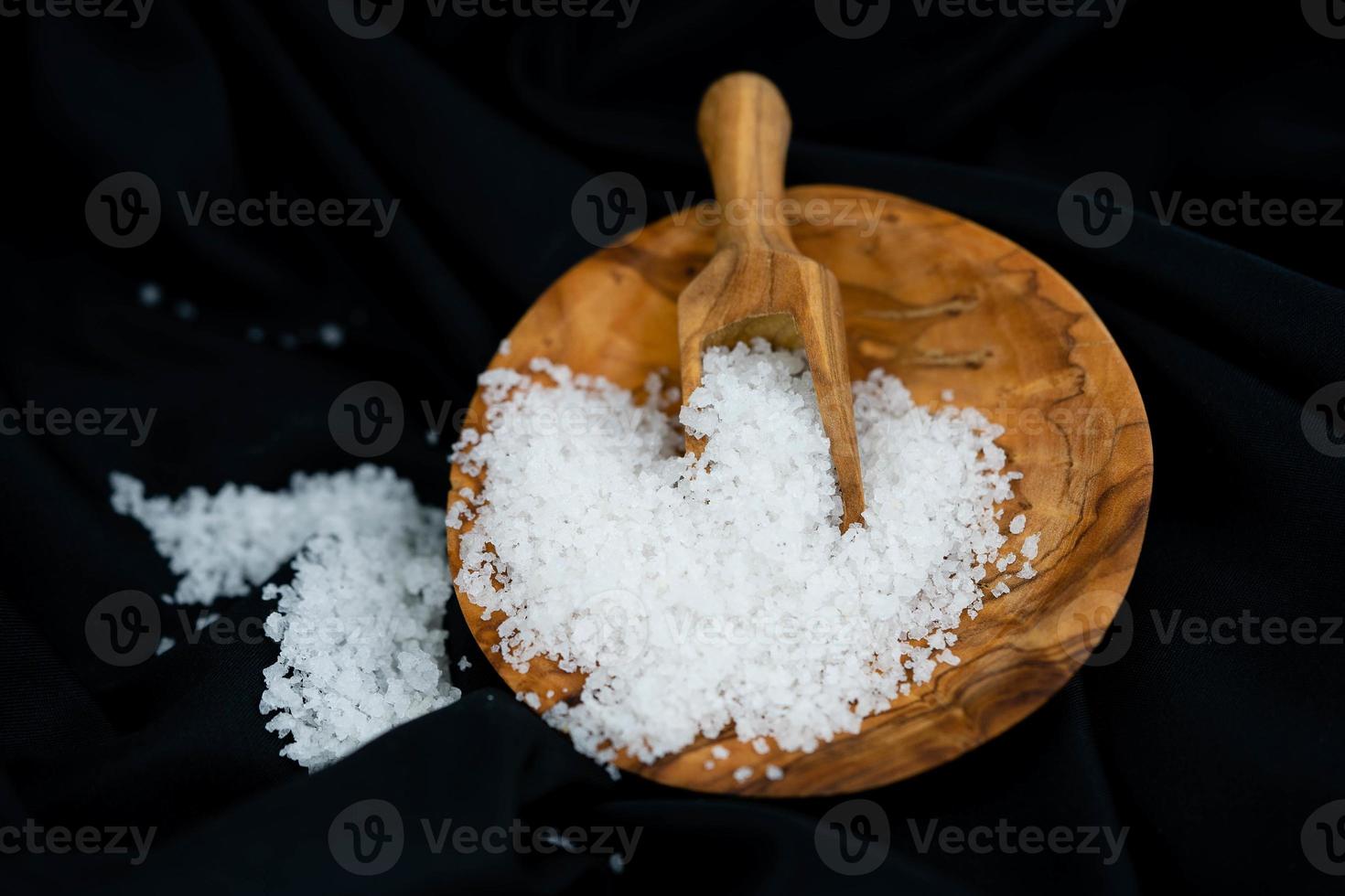 many salt crystals on olive wood photo