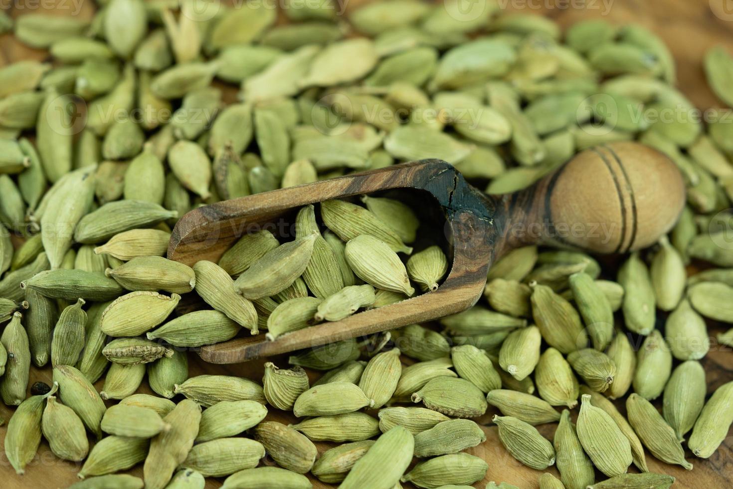 green cardamom Elettaria cardamomum on olive wood photo