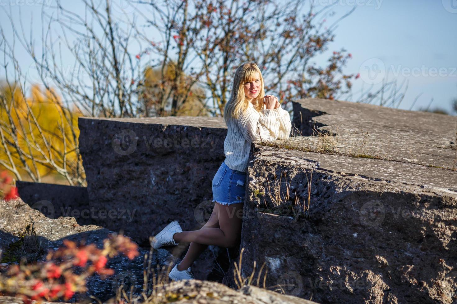 aerial view on girl stays on rock or concrete ruined structure photo