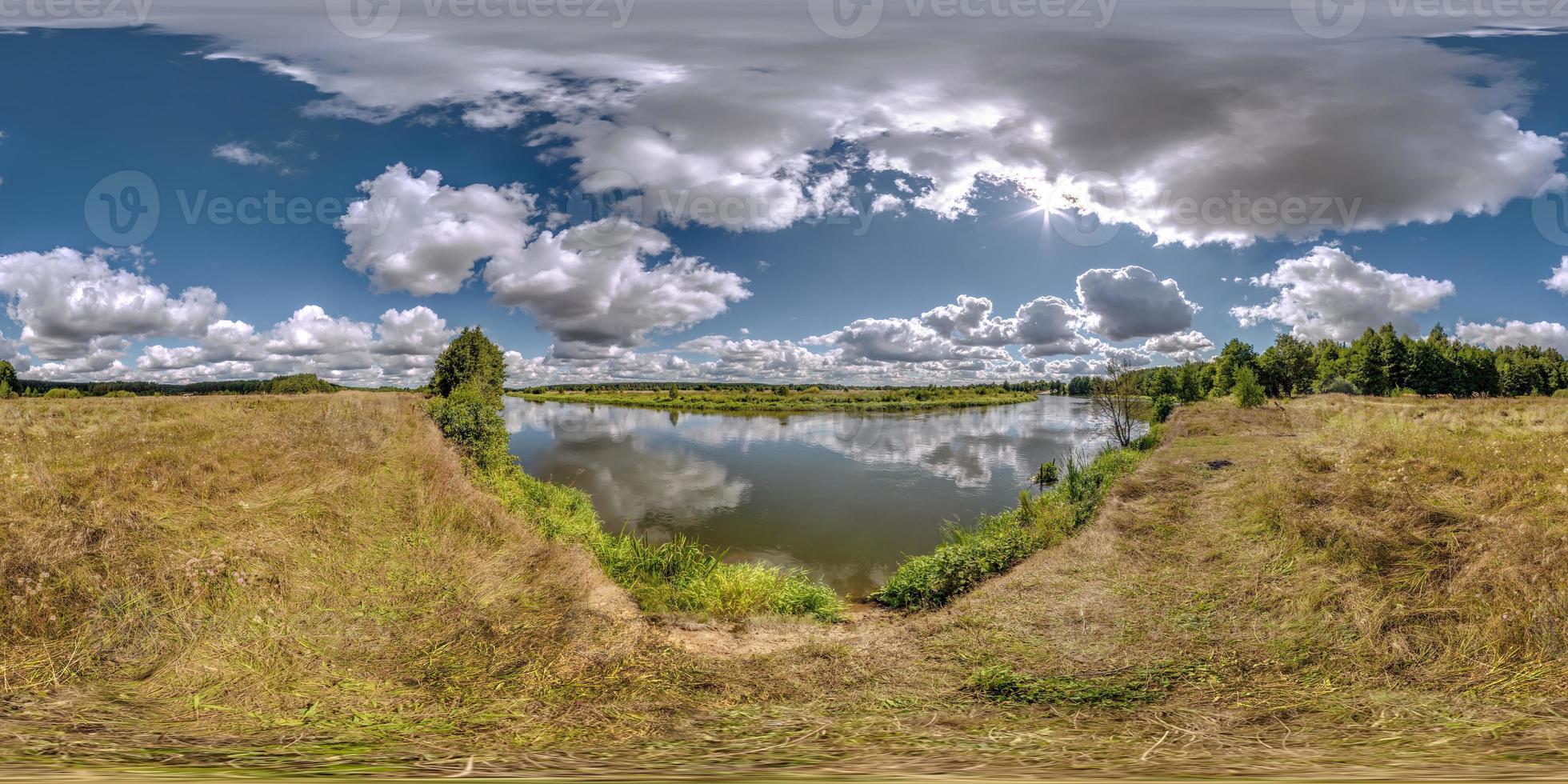 full seamless spherical hdri 360 panorama view on grass coast of huge lake or river in sunny summer day and windy weather with beautiful clouds in equirectangular projection, VR content photo