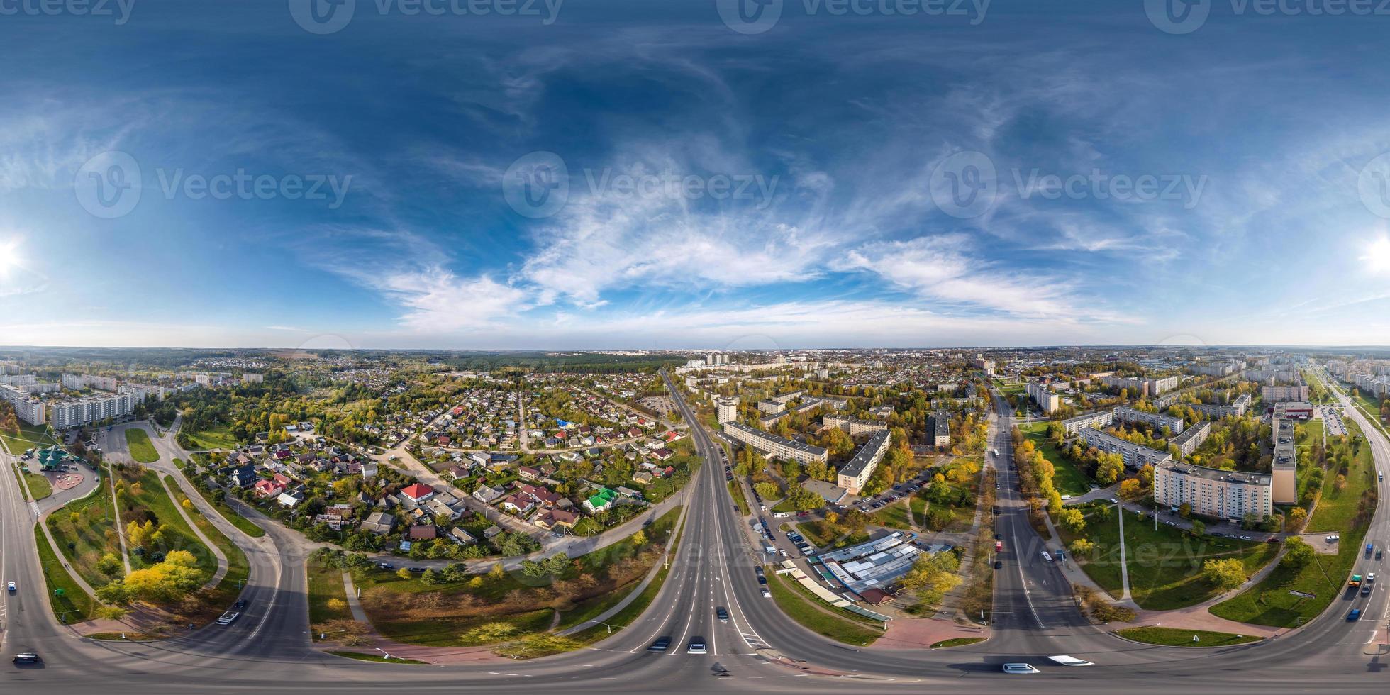 aerial full seamless spherical hdri 360 panorama view above road junction with traffic in small provincial town with private sector and high-rise apartment buildings in equirectangular projection. photo