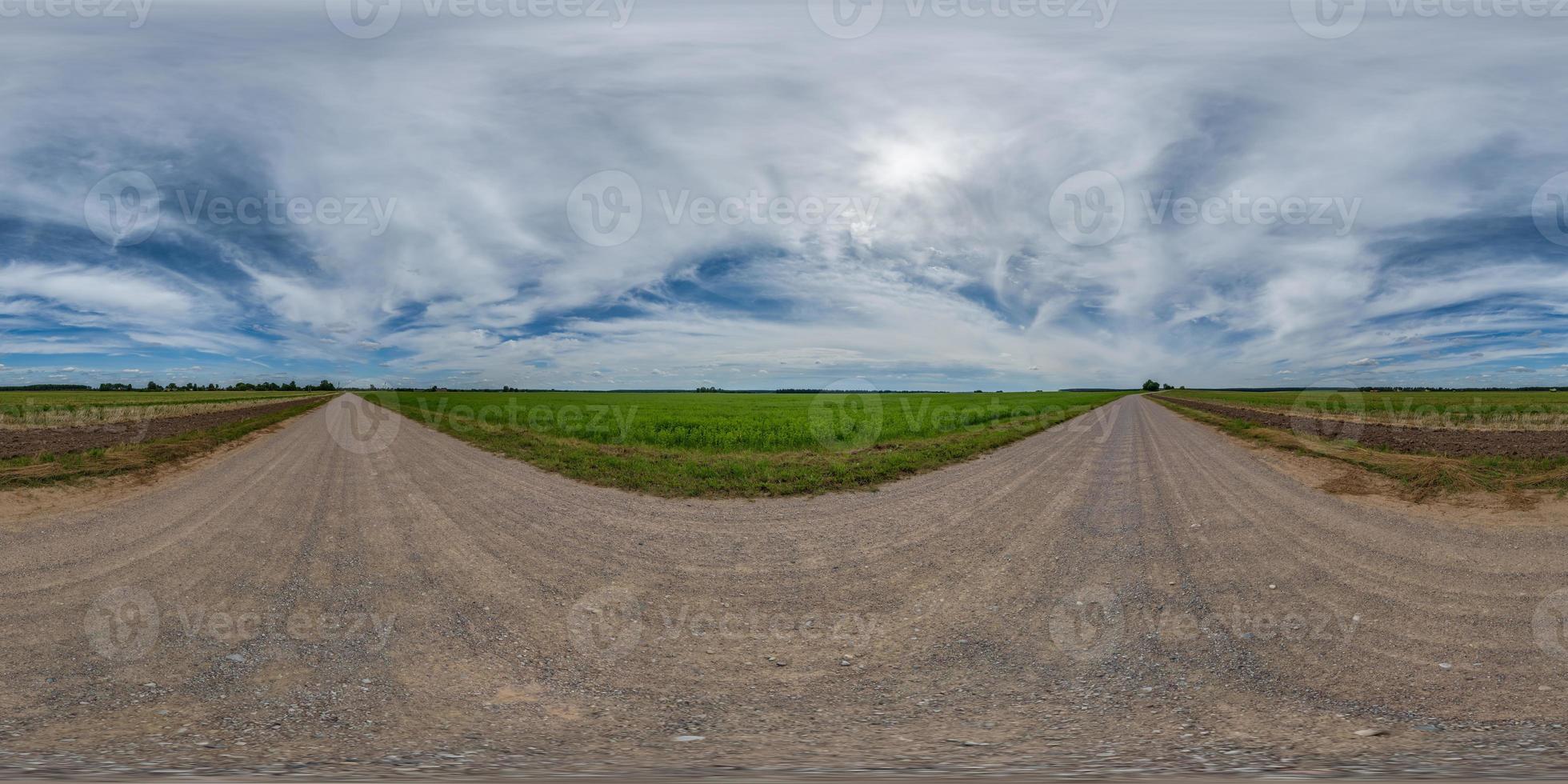 full seamless spherical hdri 360 panorama view on no traffic gravel road among fields with overcast sky and white clouds in equirectangular projection,can be used as replacement for sky in panoramas photo