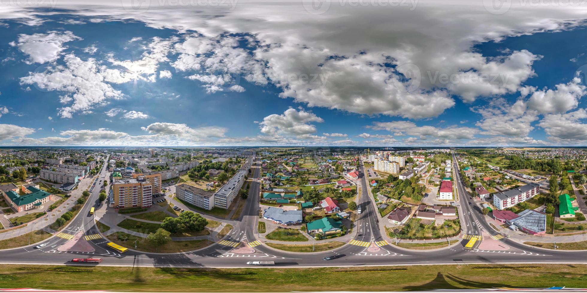 aerial full seamless spherical hdri 360 panorama view above road junction with traffic in small provincial town with private sector and high-rise apartment buildings in equirectangular projection. photo