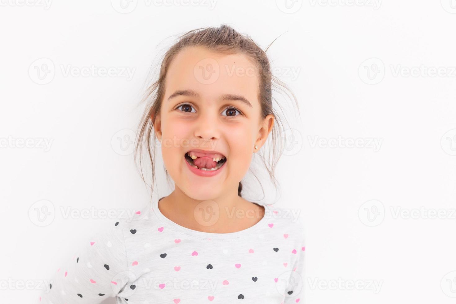 Little girl first tooth missing on a white background photo