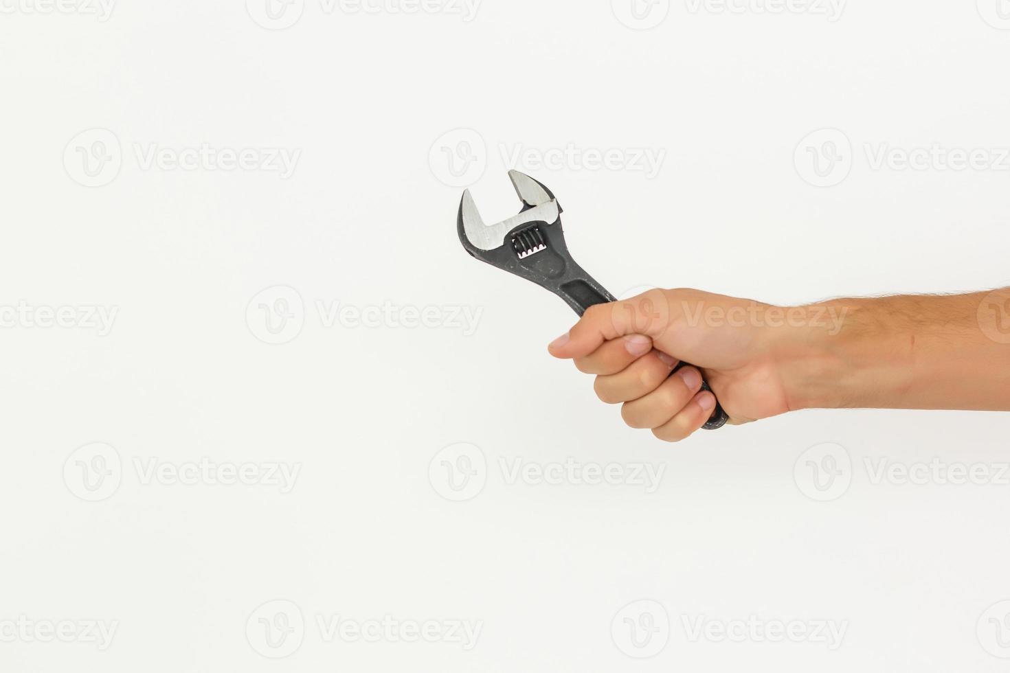 Partial view of man holding monkey wrench isolated on white photo