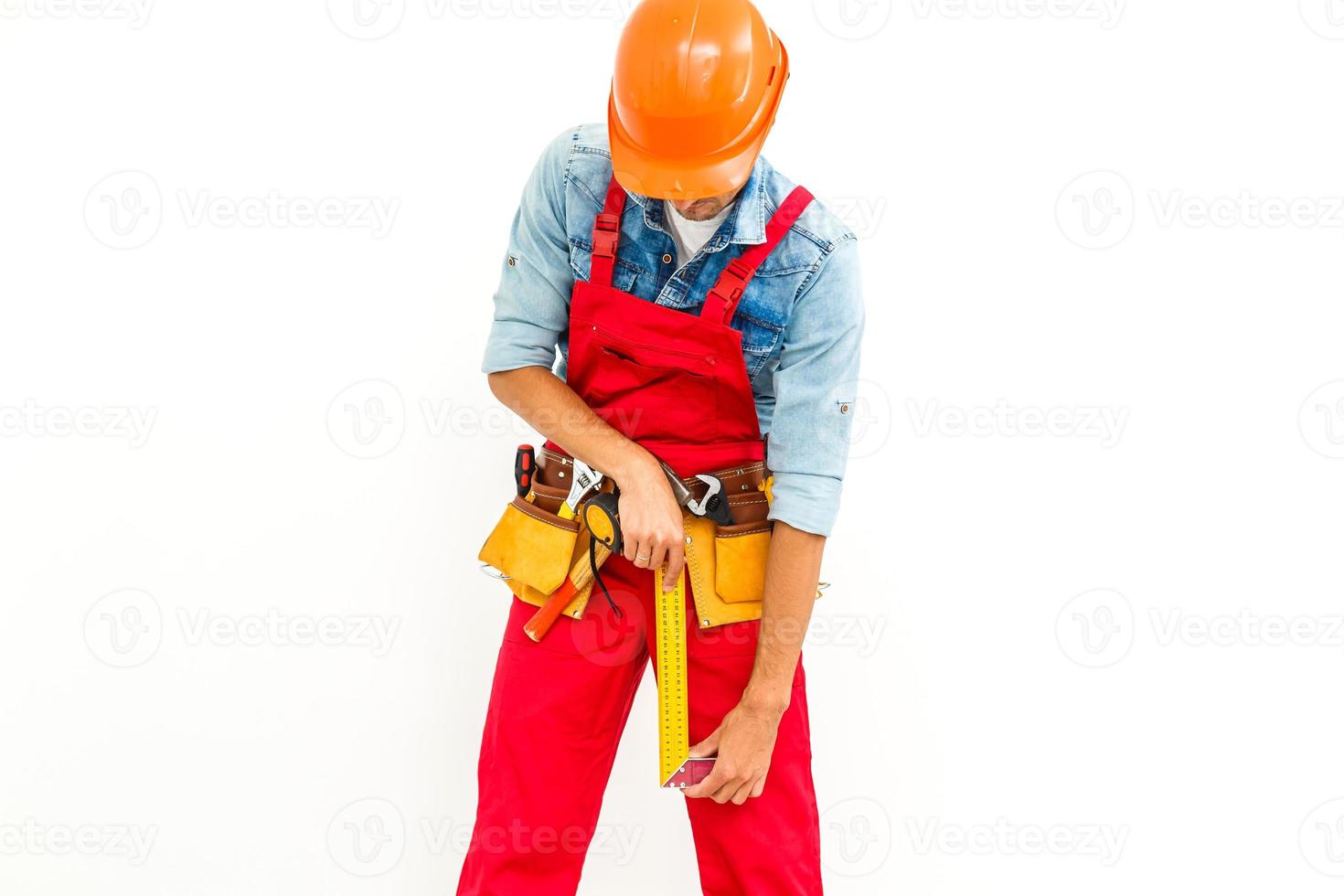 Worker in hard hat measure with ruler. Isolated on a white background. photo