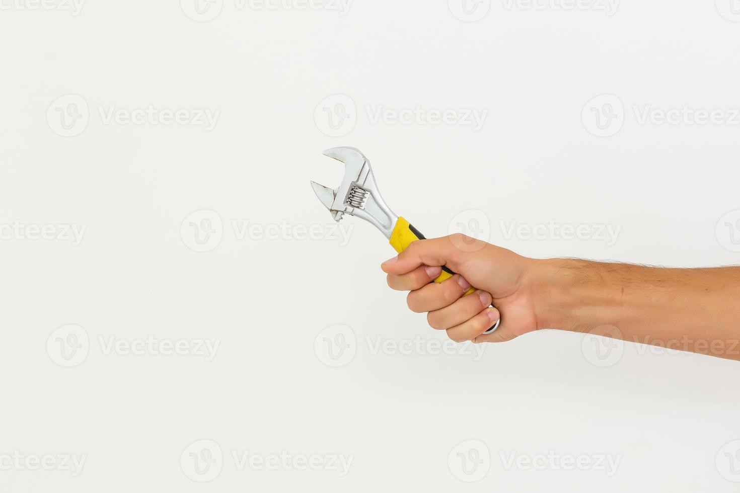 Partial view of man holding monkey wrench isolated on white photo