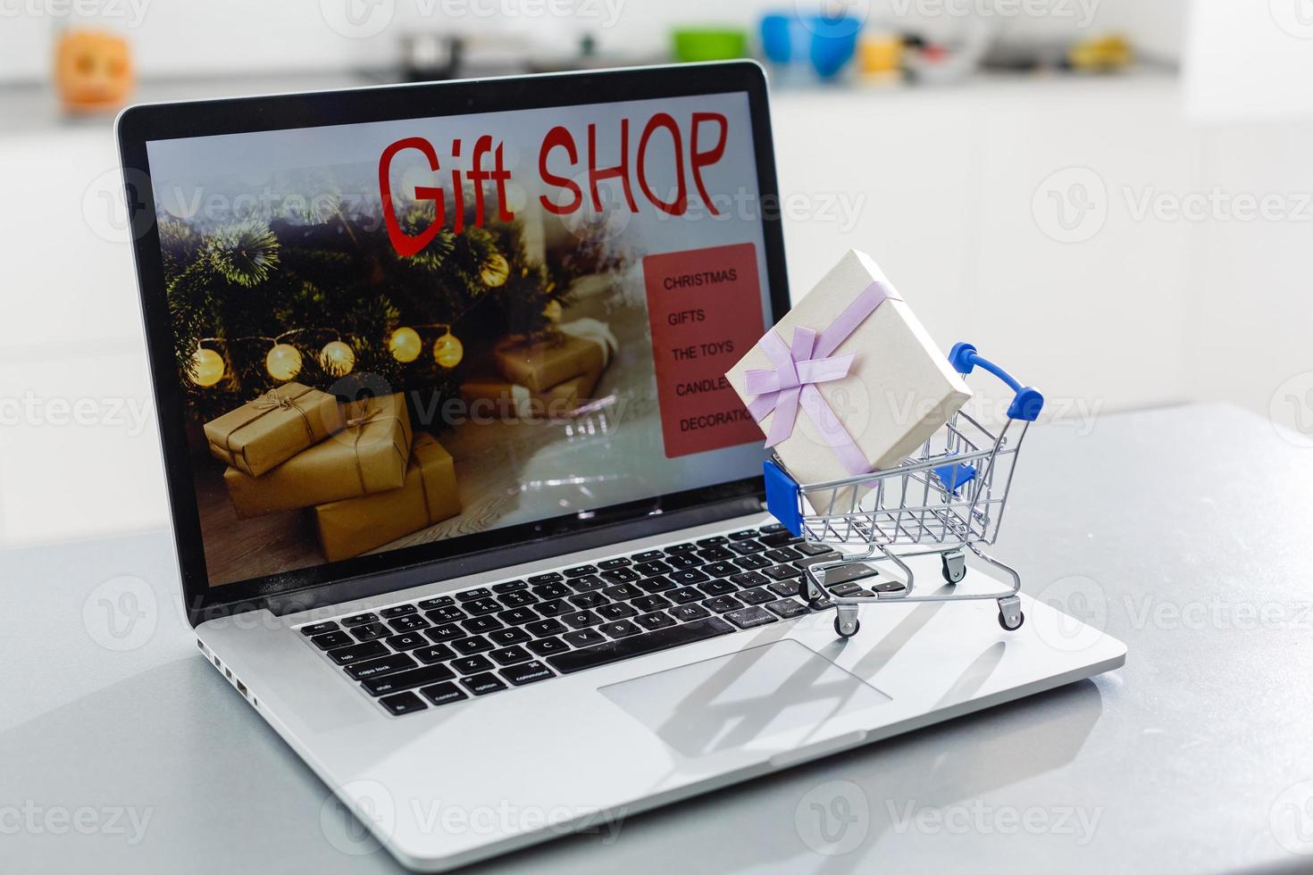 Shopping cart with gift box on the keyboard of computer. photo