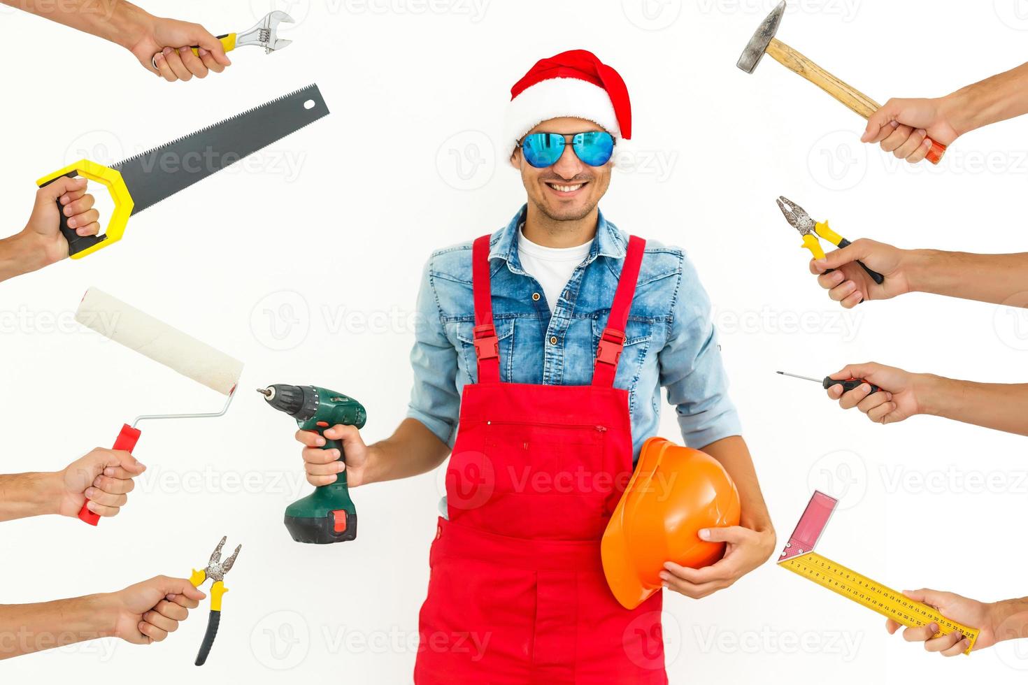 trabajador con sombrero de santa, manos con herramientas foto