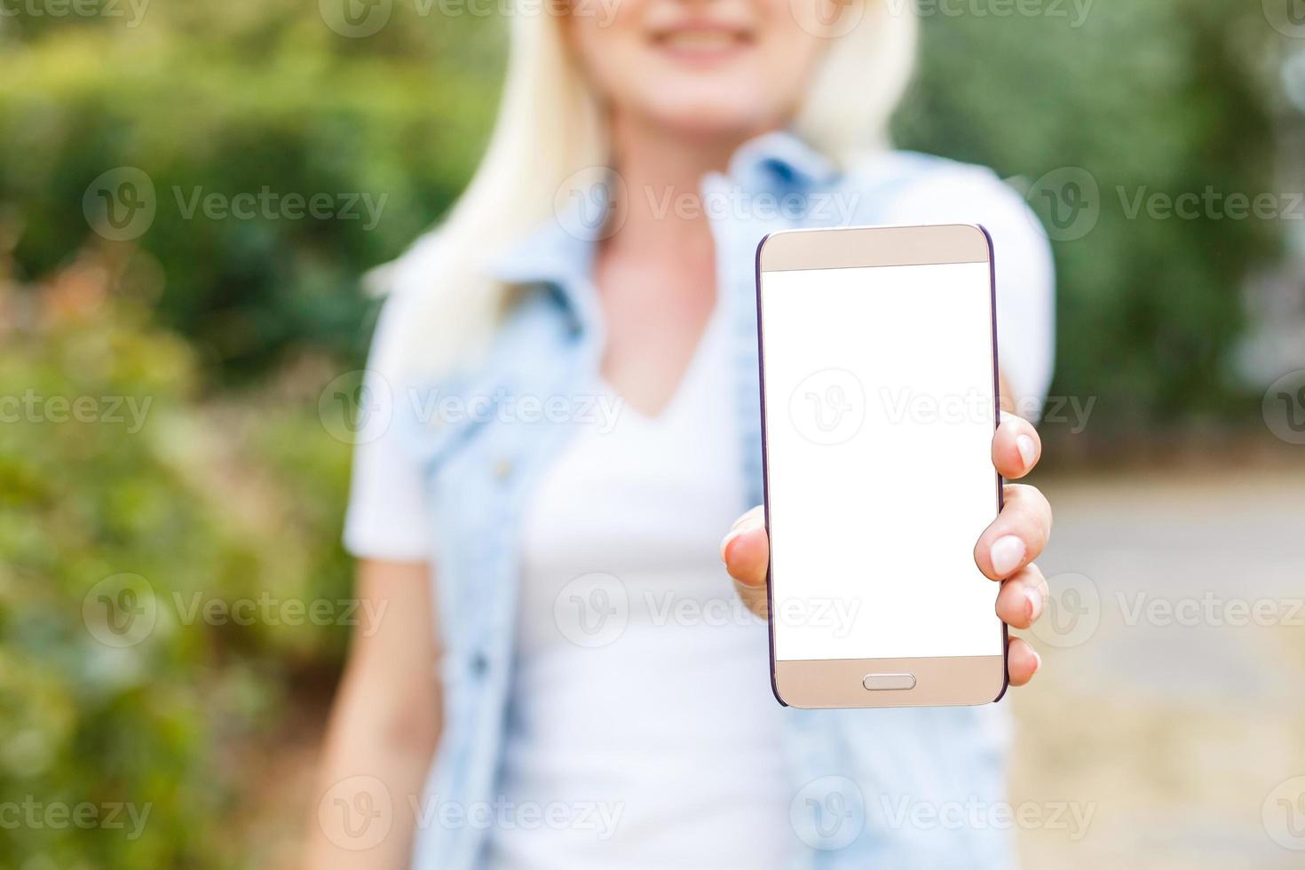 Smiling woman with a smartphone photo