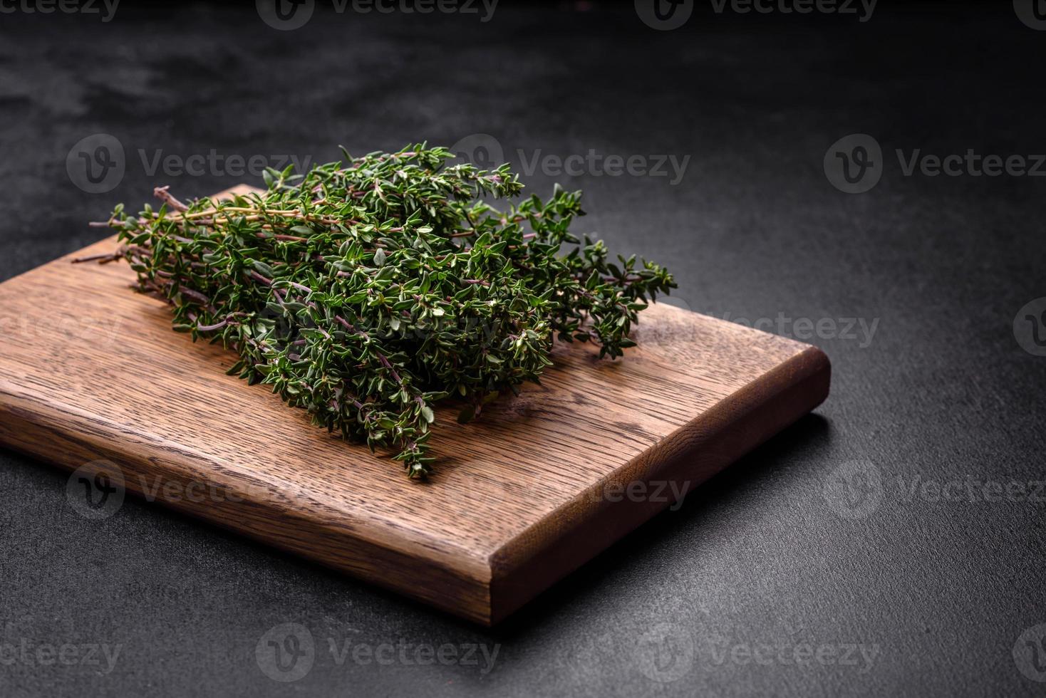 Bunch of fresh picked thyme on a dark concrete background photo