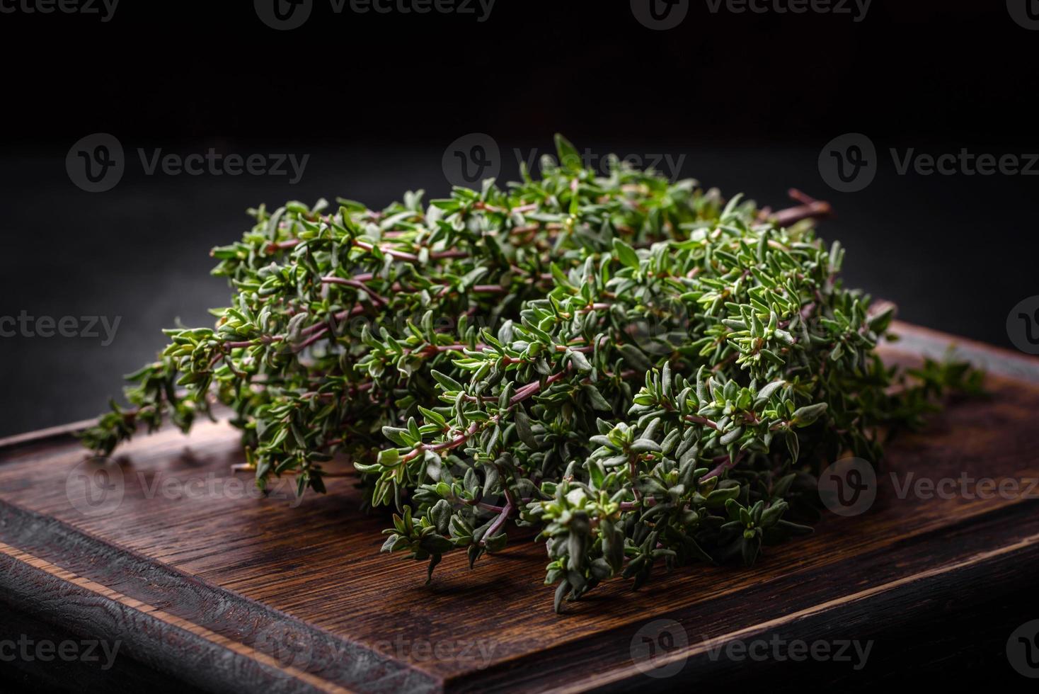 Bunch of fresh picked thyme on a dark concrete background photo