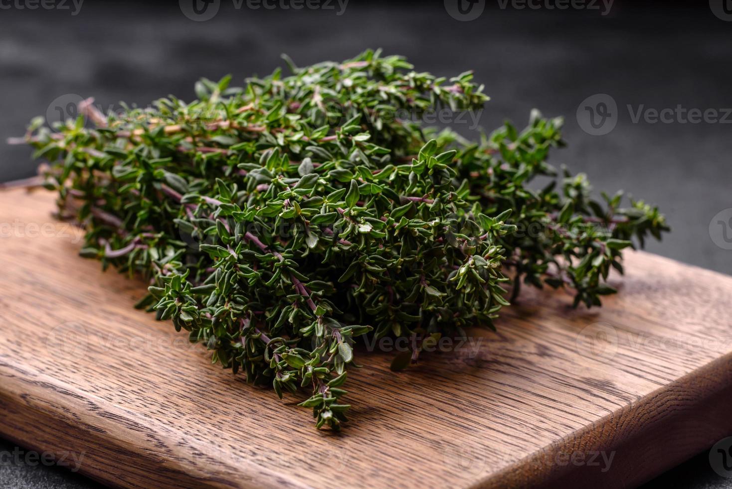 Bunch of fresh picked thyme on a dark concrete background photo