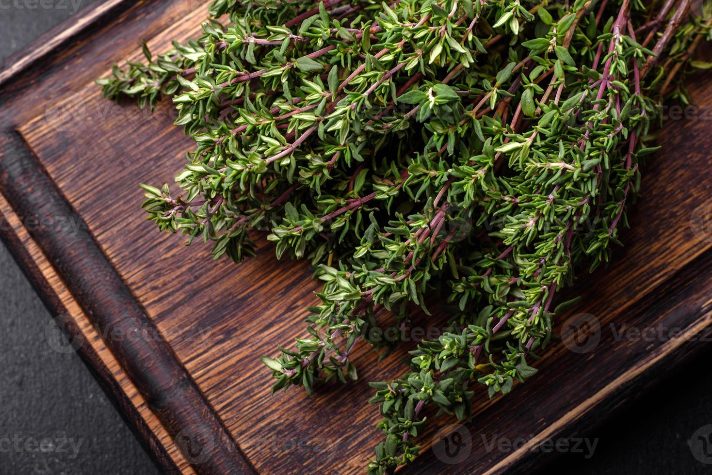 Bunch of fresh picked thyme on a dark concrete background photo