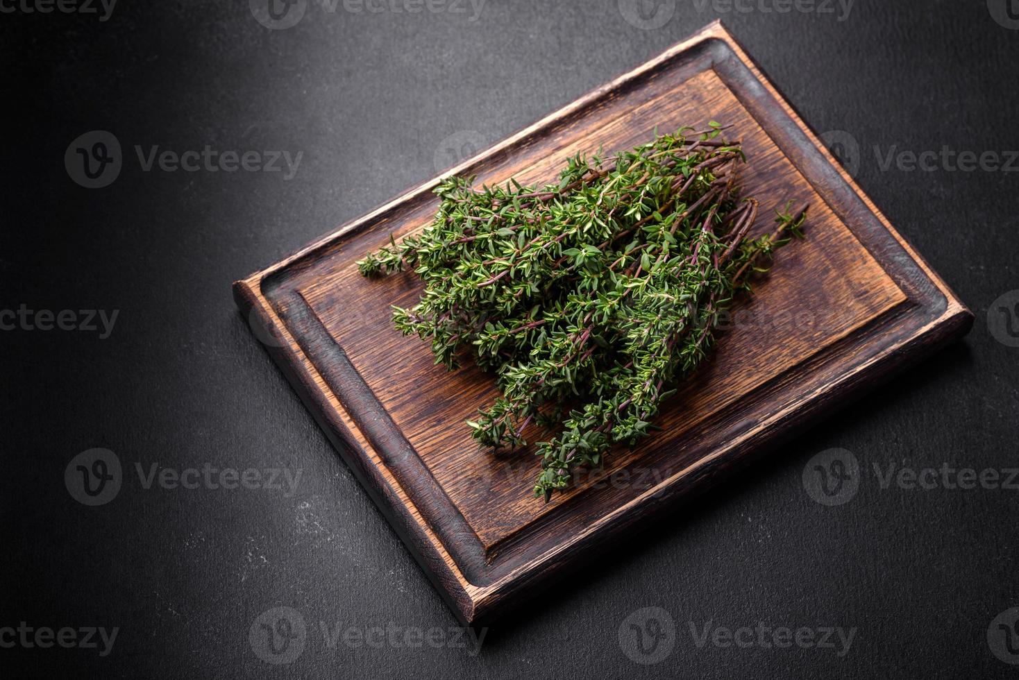 Bunch of fresh picked thyme on a dark concrete background photo