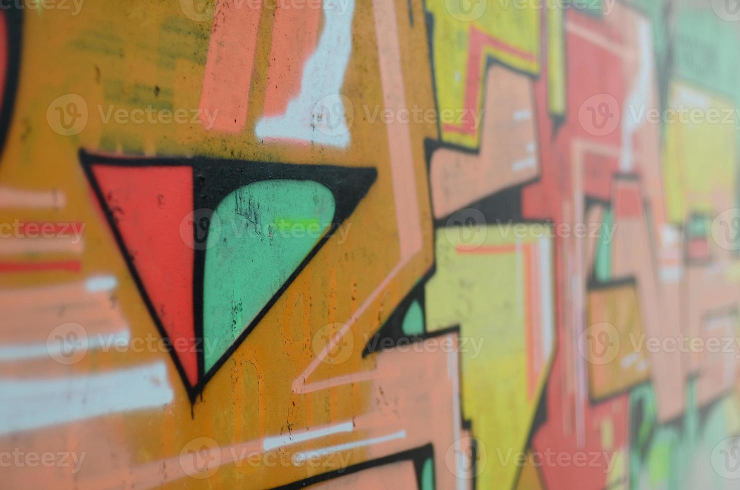 Background image with a colored graffiti pattern, which is applied to the concrete wall with aerosol paints. A lot of contours and fragments filled with paint, forming an interesting composition photo