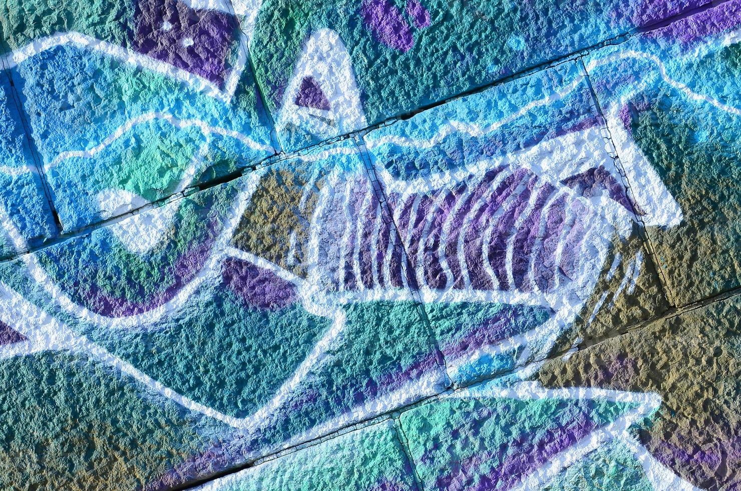 Fragment of graffiti drawings. The old wall decorated with paint stains in the style of street art culture. Colored background texture in cold tones photo