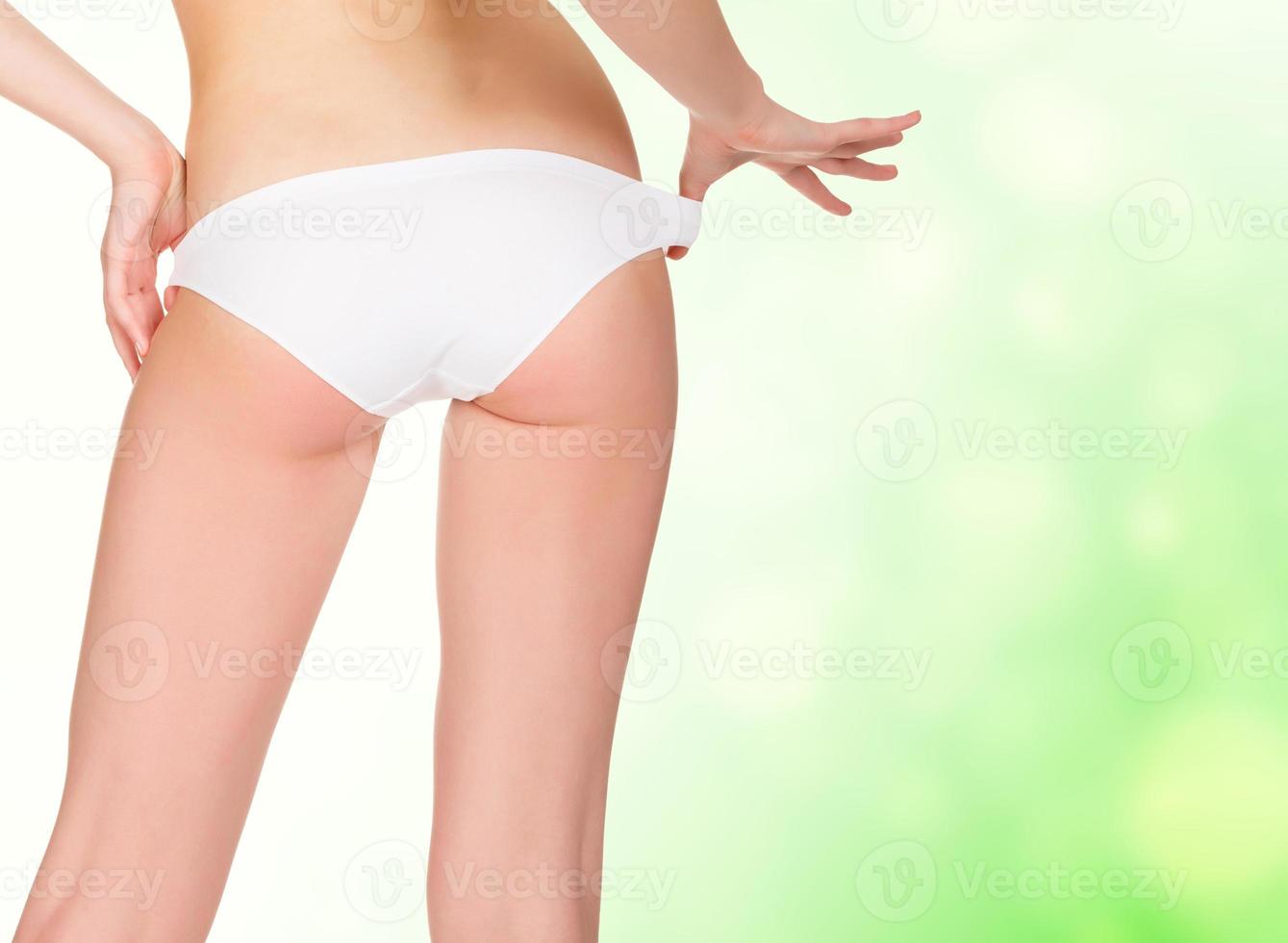 female backside, green blurred background photo