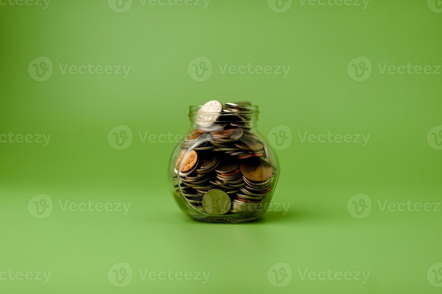 Money in a glass jar, coin savings concept photo