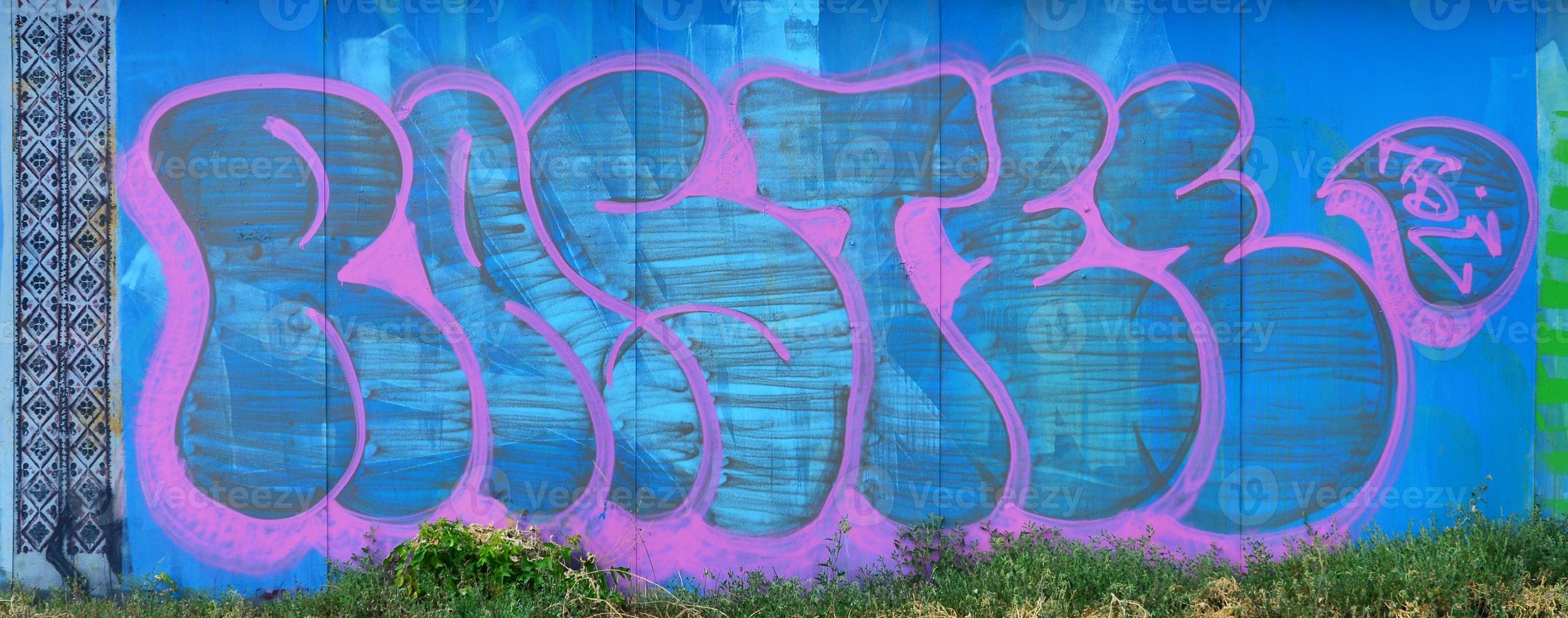 The old wall, painted in color graffiti drawing blue aerosol paints. Background image on the theme of drawing graffiti and street art photo
