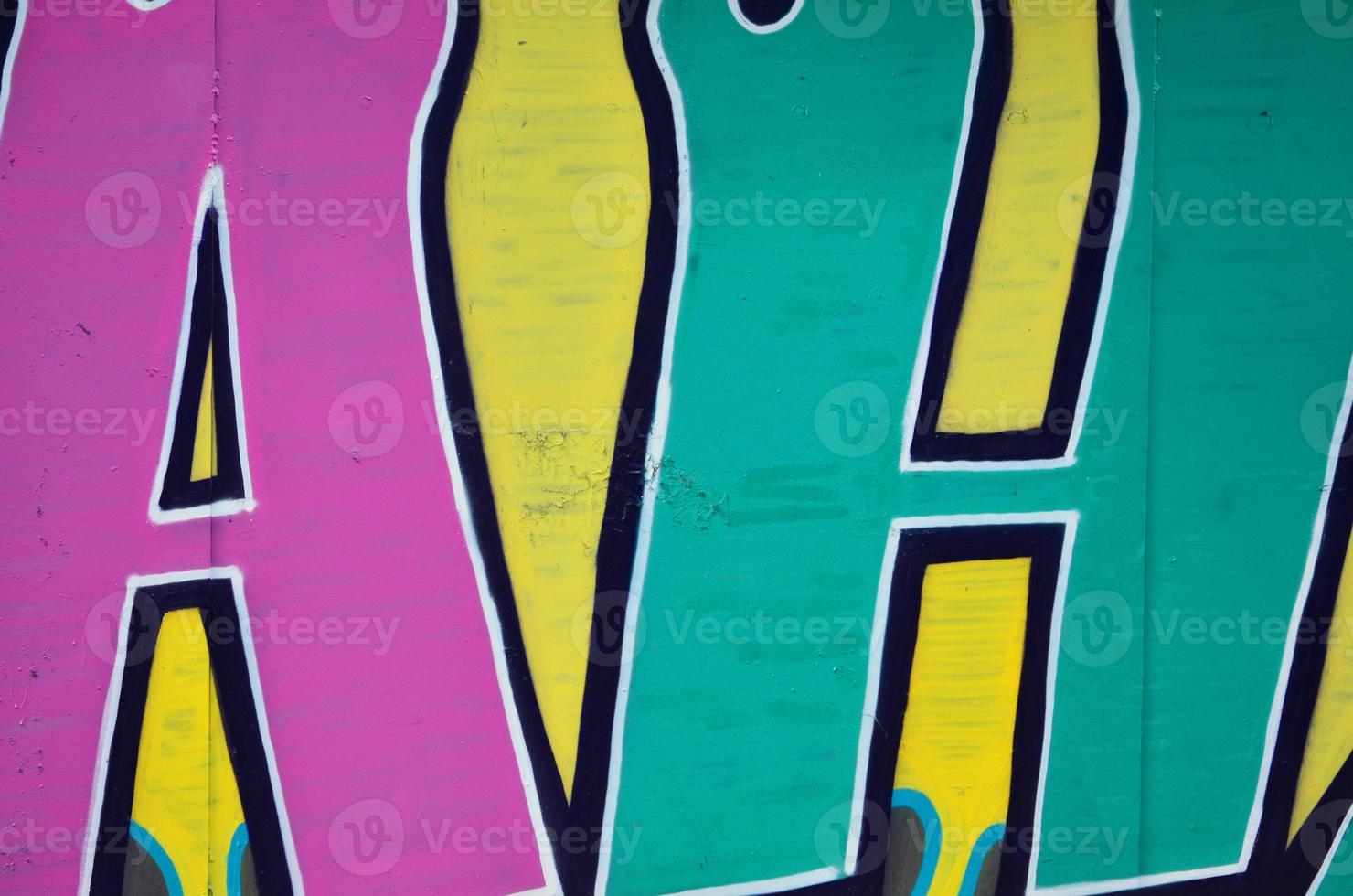 The old wall, painted in color graffiti drawing green aerosol paints. Background image on the theme of drawing graffiti and street art photo
