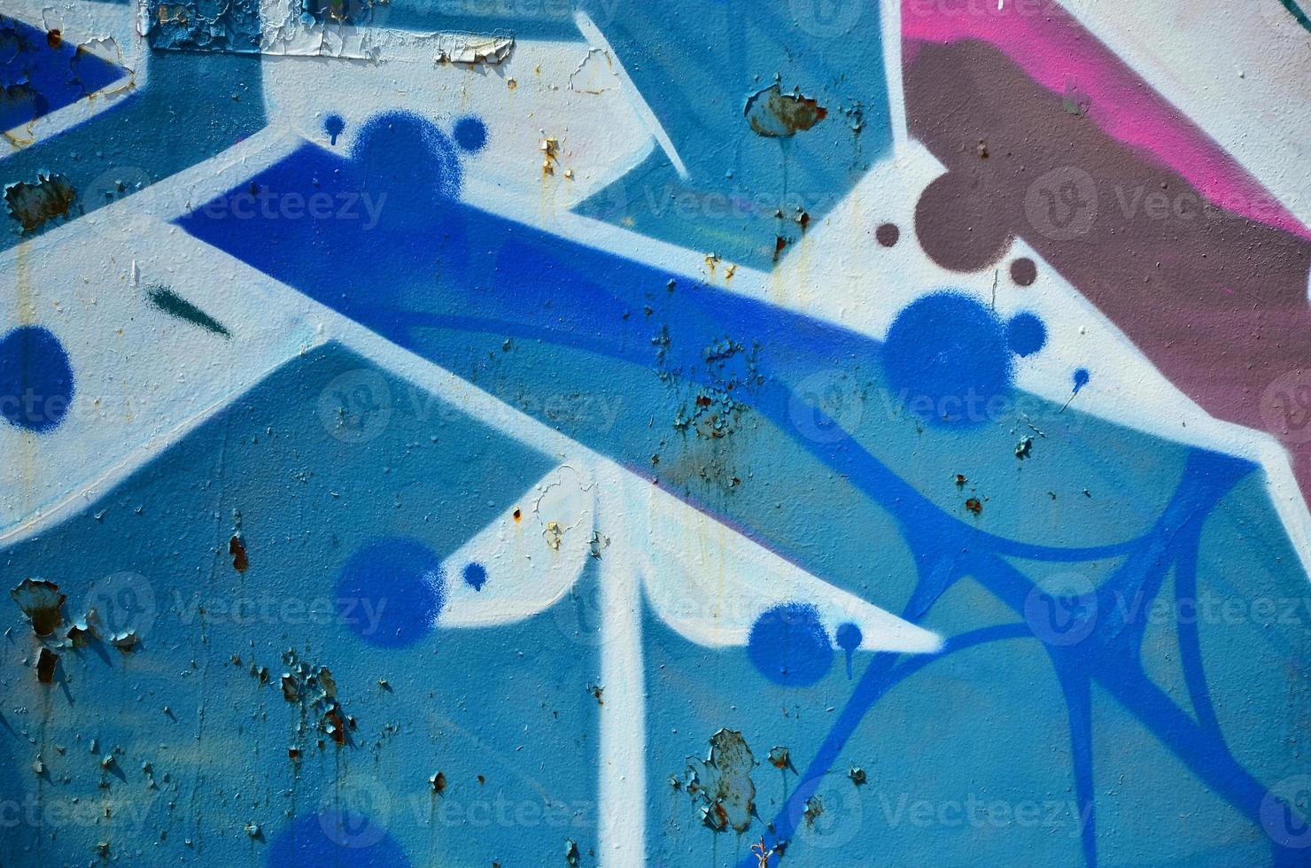 The old wall, painted in color graffiti drawing blue aerosol paints. Background image on the theme of drawing graffiti and street art photo