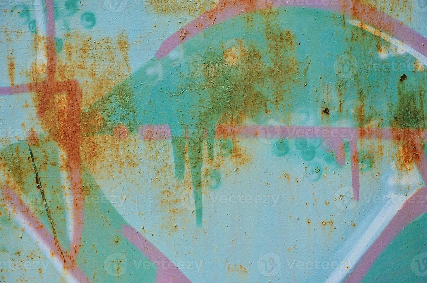The old wall, painted in color graffiti drawing green aerosol paints. Background image on the theme of drawing graffiti and street art photo