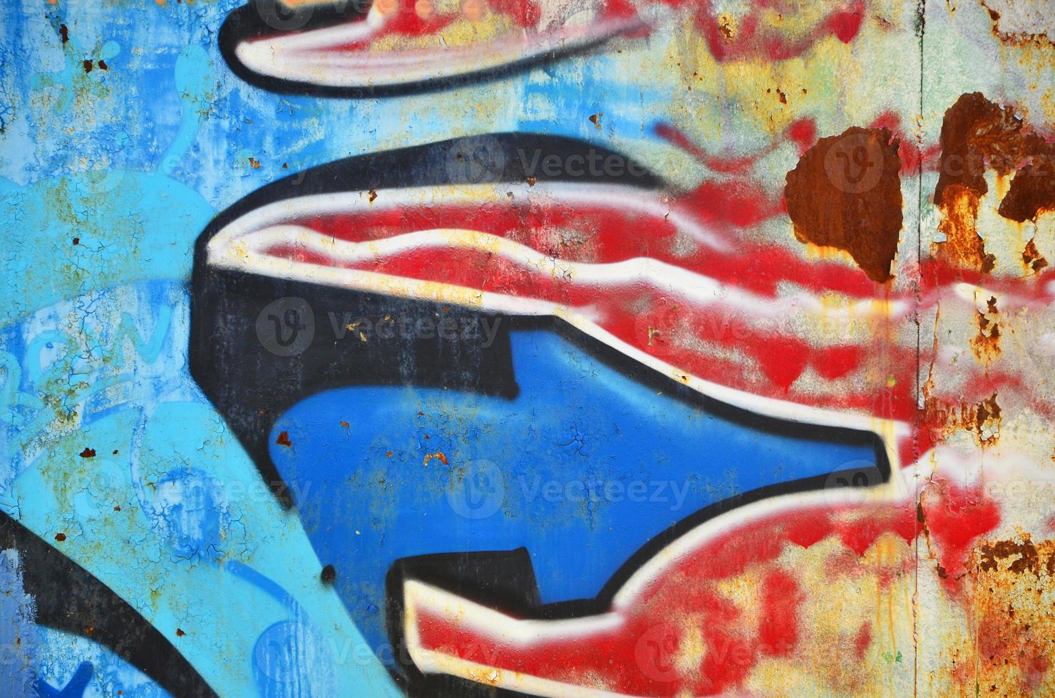 The old wall, painted in color graffiti drawing blue aerosol paints. Background image on the theme of drawing graffiti and street art photo