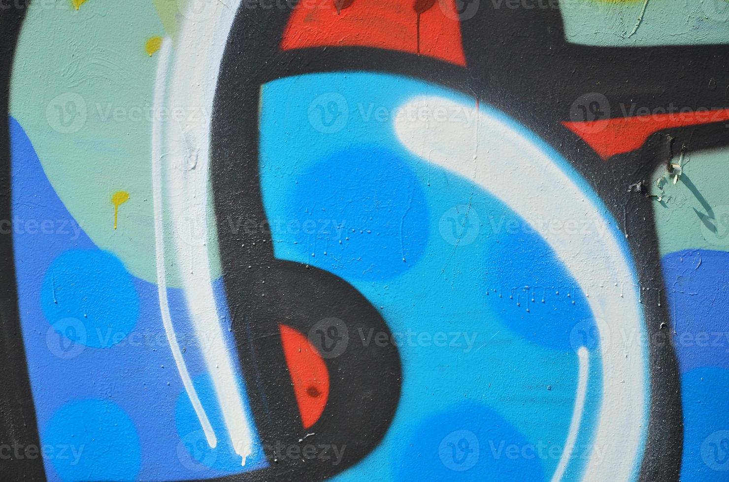 The old wall, painted in color graffiti drawing blue aerosol paints. Background image on the theme of drawing graffiti and street art photo