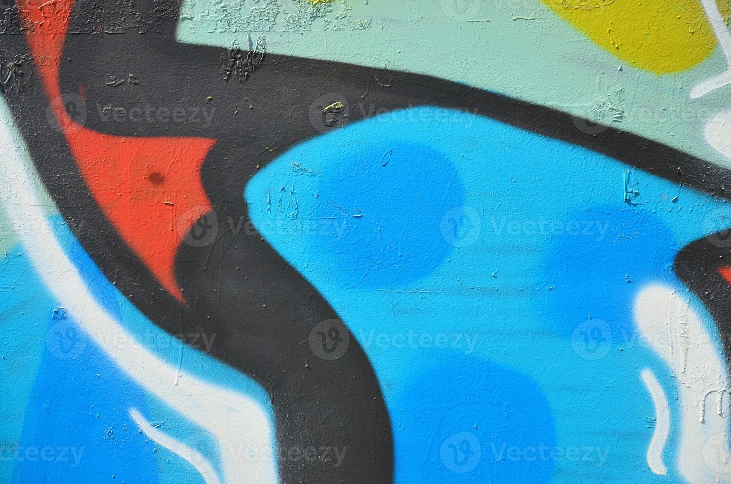 The old wall, painted in color graffiti drawing blue aerosol paints. Background image on the theme of drawing graffiti and street art photo
