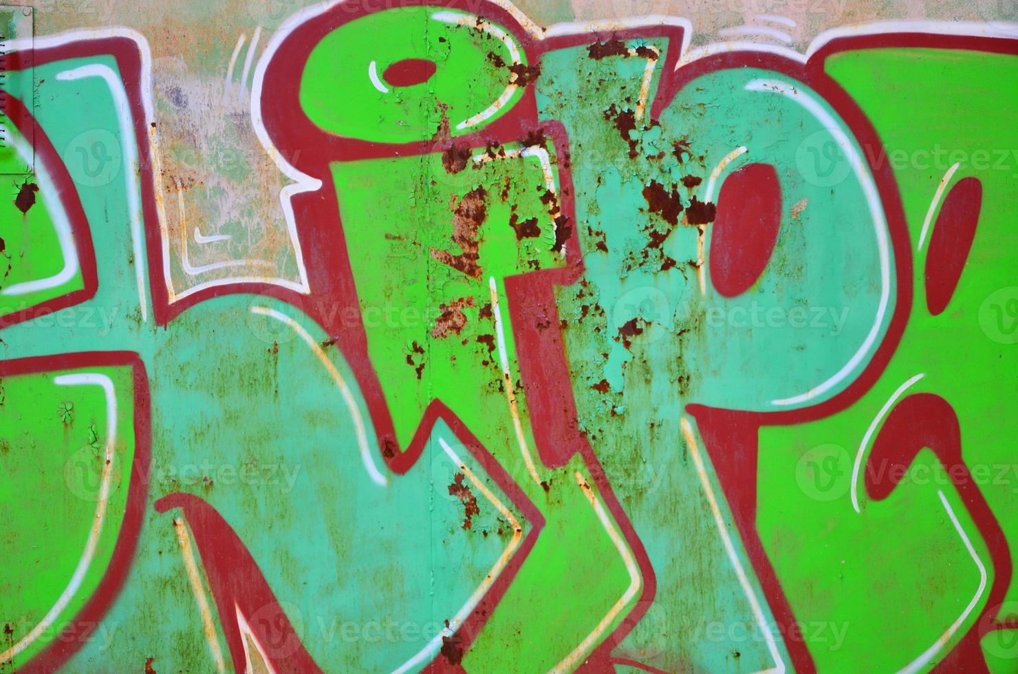 The old wall, painted in color graffiti drawing green aerosol paints. Background image on the theme of drawing graffiti and street art photo