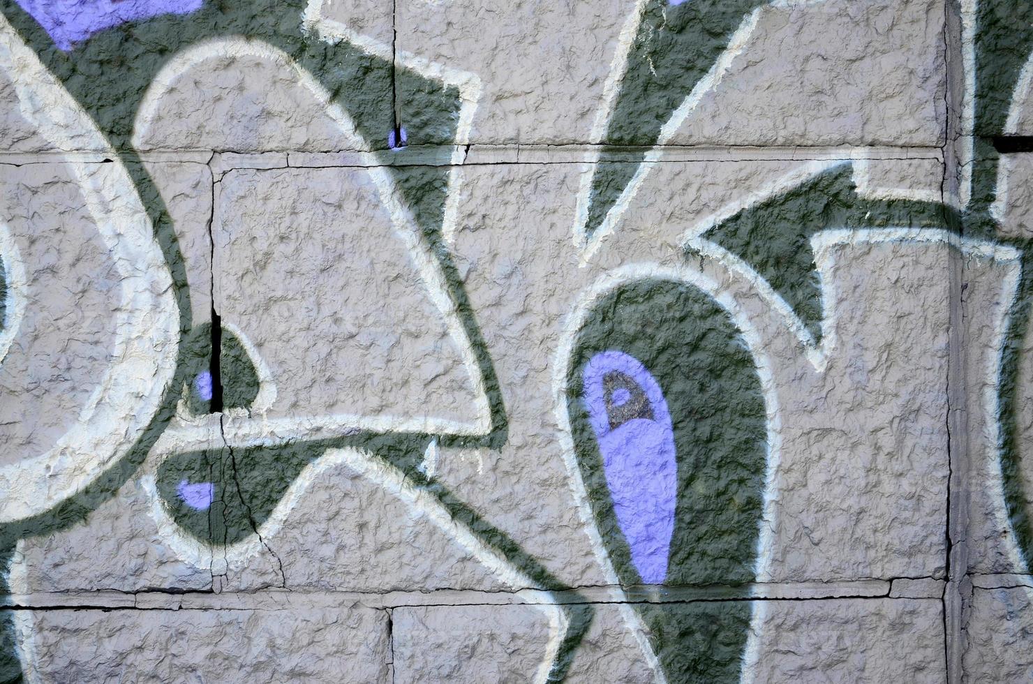 Fragment of graffiti drawings. The old wall decorated with paint stains in the style of street art culture. Colored background texture in purple tones photo