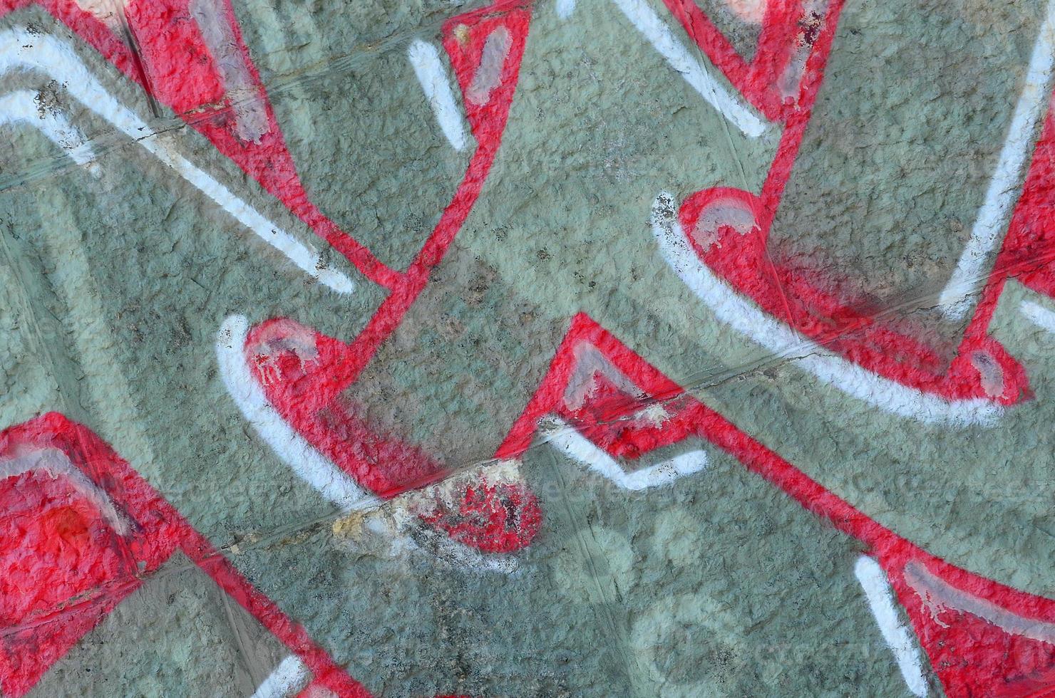 Fragment of graffiti drawings. The old wall decorated with paint stains in the style of street art culture. Colored background texture in warm tones photo