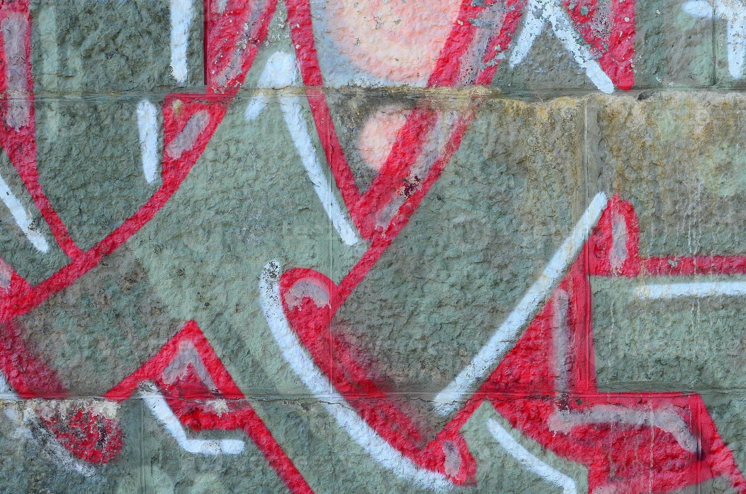 Fragment of graffiti drawings. The old wall decorated with paint stains in the style of street art culture. Colored background texture in warm tones photo