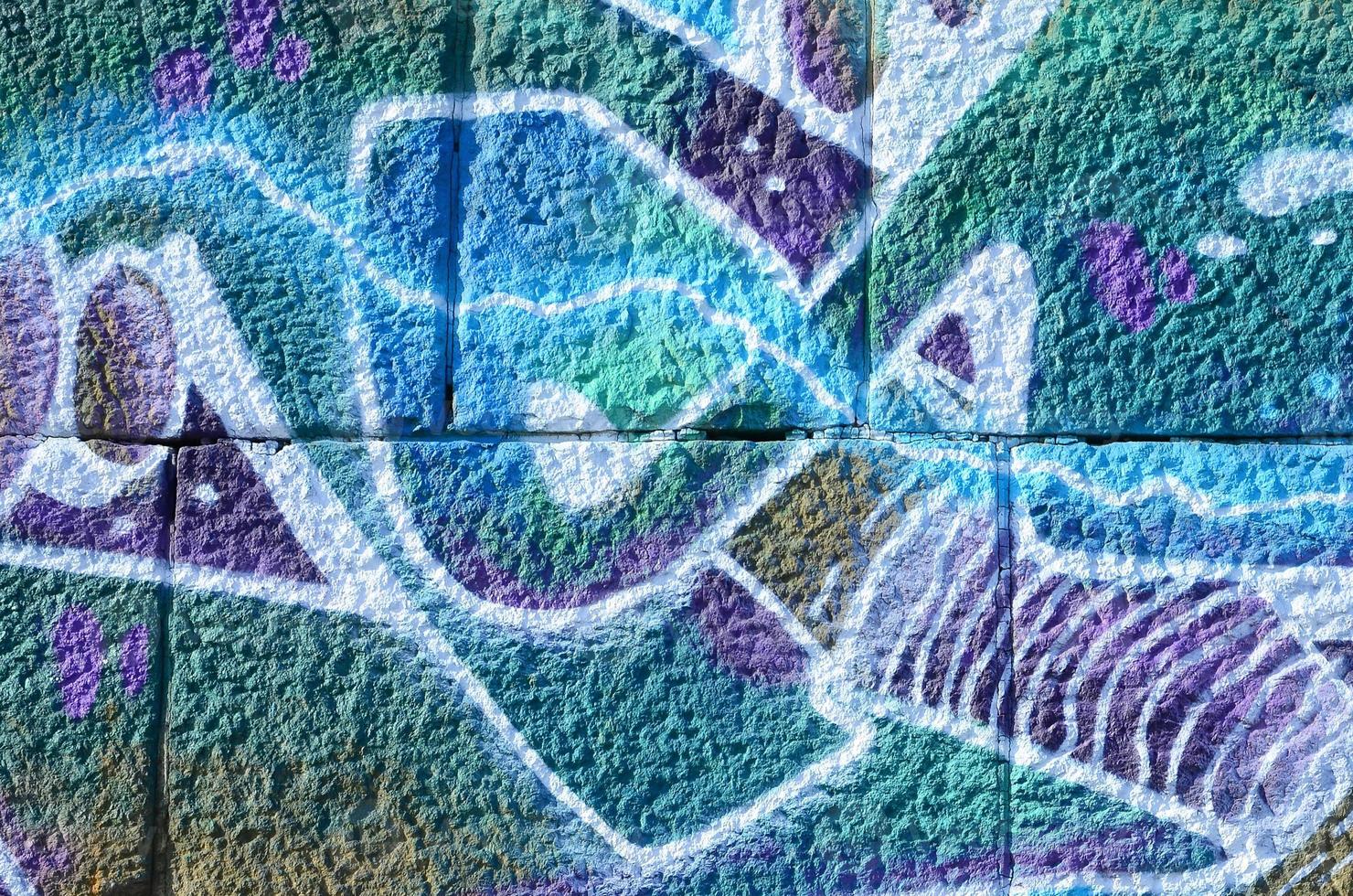 Fragment of graffiti drawings. The old wall decorated with paint stains in the style of street art culture. Colored background texture in cold tones photo