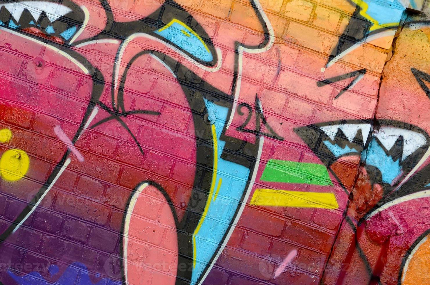 Abstract colorful fragment of graffiti paintings on old brick wall. Street art composition with parts of unwritten letters and multicolored stains. Subcultural background texture photo