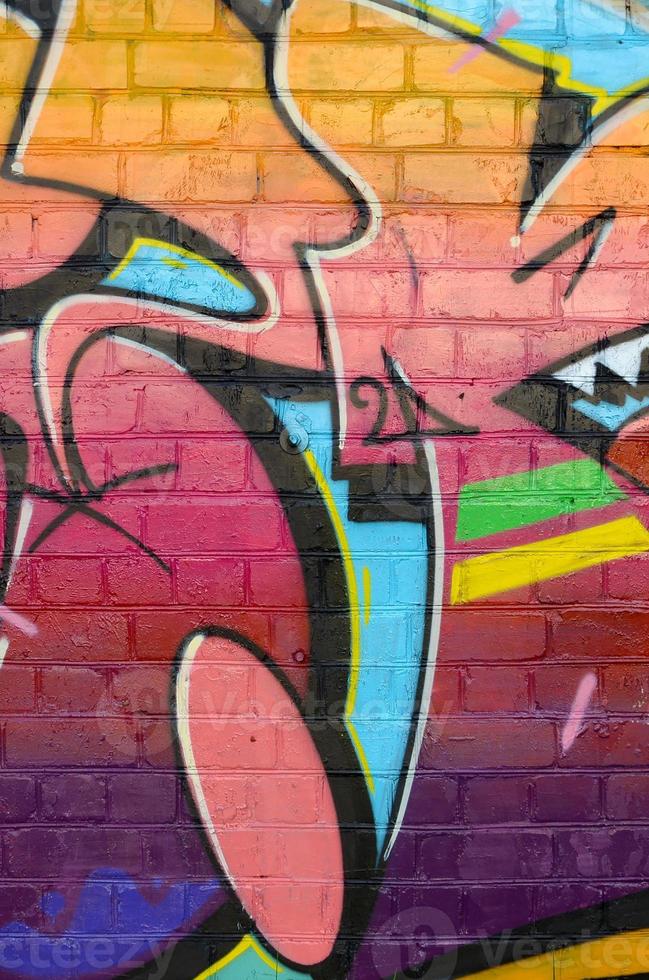 Abstract colorful fragment of graffiti paintings on old brick wall. Street art composition with parts of unwritten letters and multicolored stains. Subcultural background texture photo
