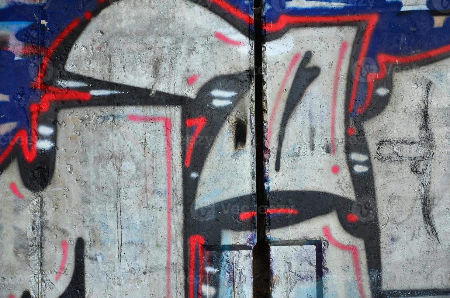 Texture of a fragment of the wall with graffiti painting, which is depicted on it. An image of a piece of graffiti drawing as a photo on street art and graffiti culture topics