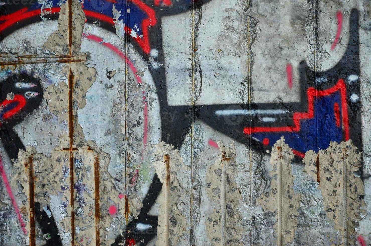 Texture of a fragment of the wall with graffiti painting, which is depicted on it. An image of a piece of graffiti drawing as a photo on street art and graffiti culture topics